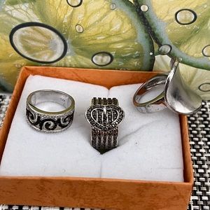Three silver rings some with diamonds